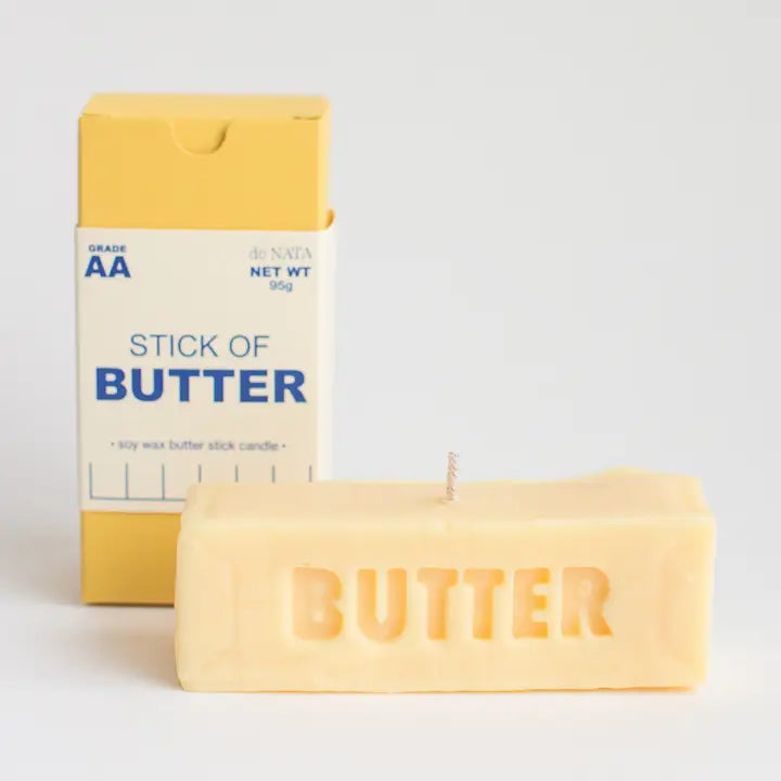 Butter-scented candle with packaging labeled 'Stick of Butter' on a light gray background