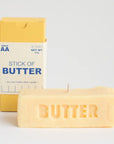Butter-scented candle with packaging labeled 'Stick of Butter' on a light gray background