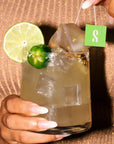Woman holding Skinny Spicy Margarita with Sachet