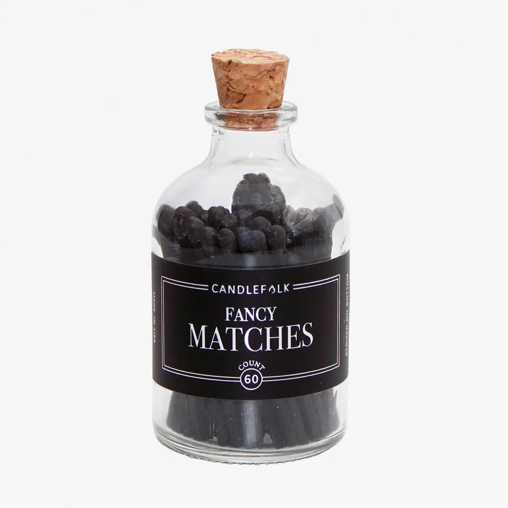 clear match jar with a black label and black matches on a white background