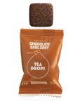 Chocolate Earl Grey tea drop with packaging on a white background