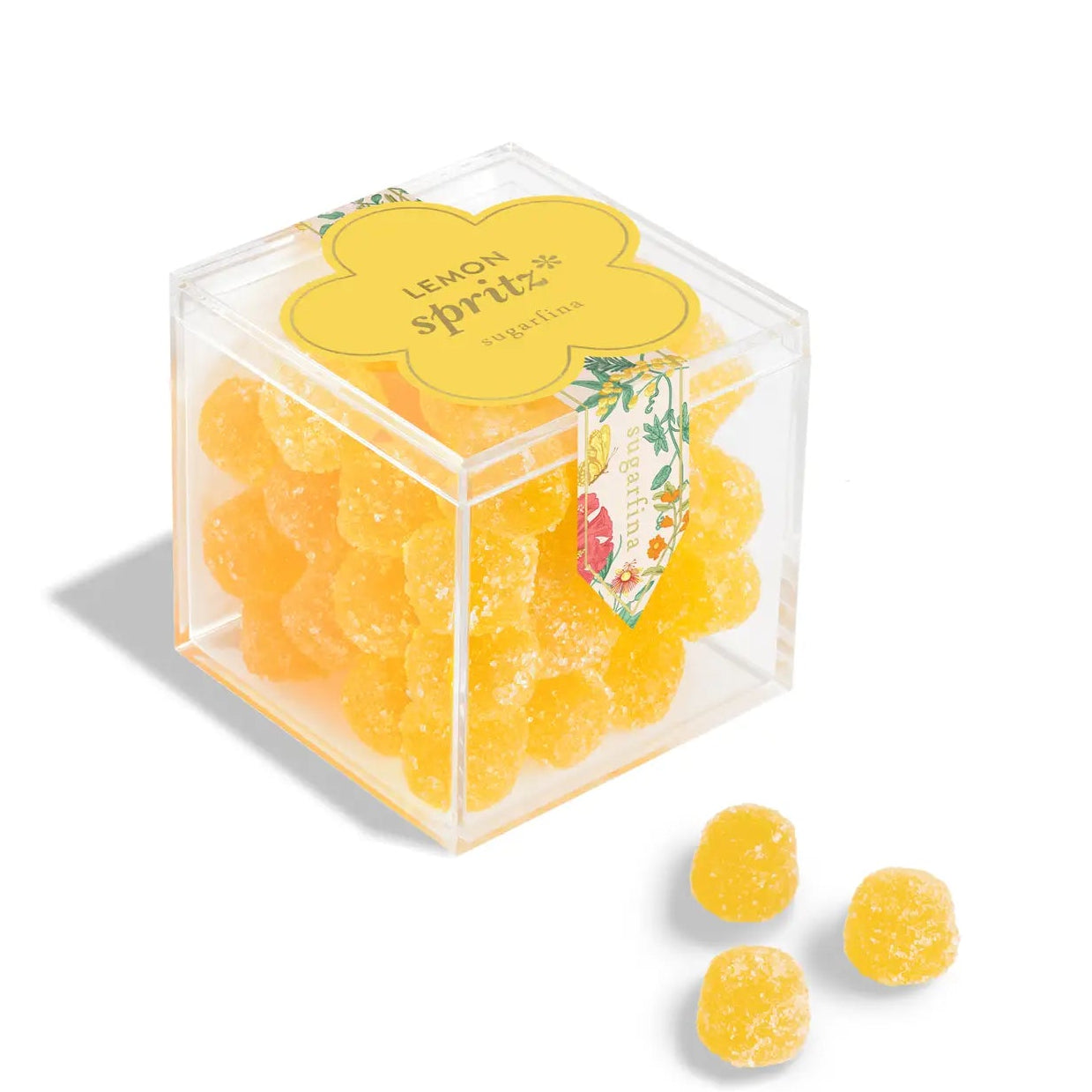 Clear cube container with yellow gummy bears labeled 'Lemon Spritz' on a white background
