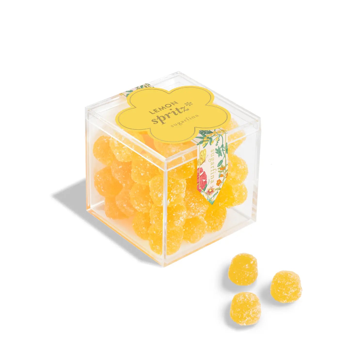 Clear cube container with yellow gummy bears labeled 'Lemon Spritz' on a white background