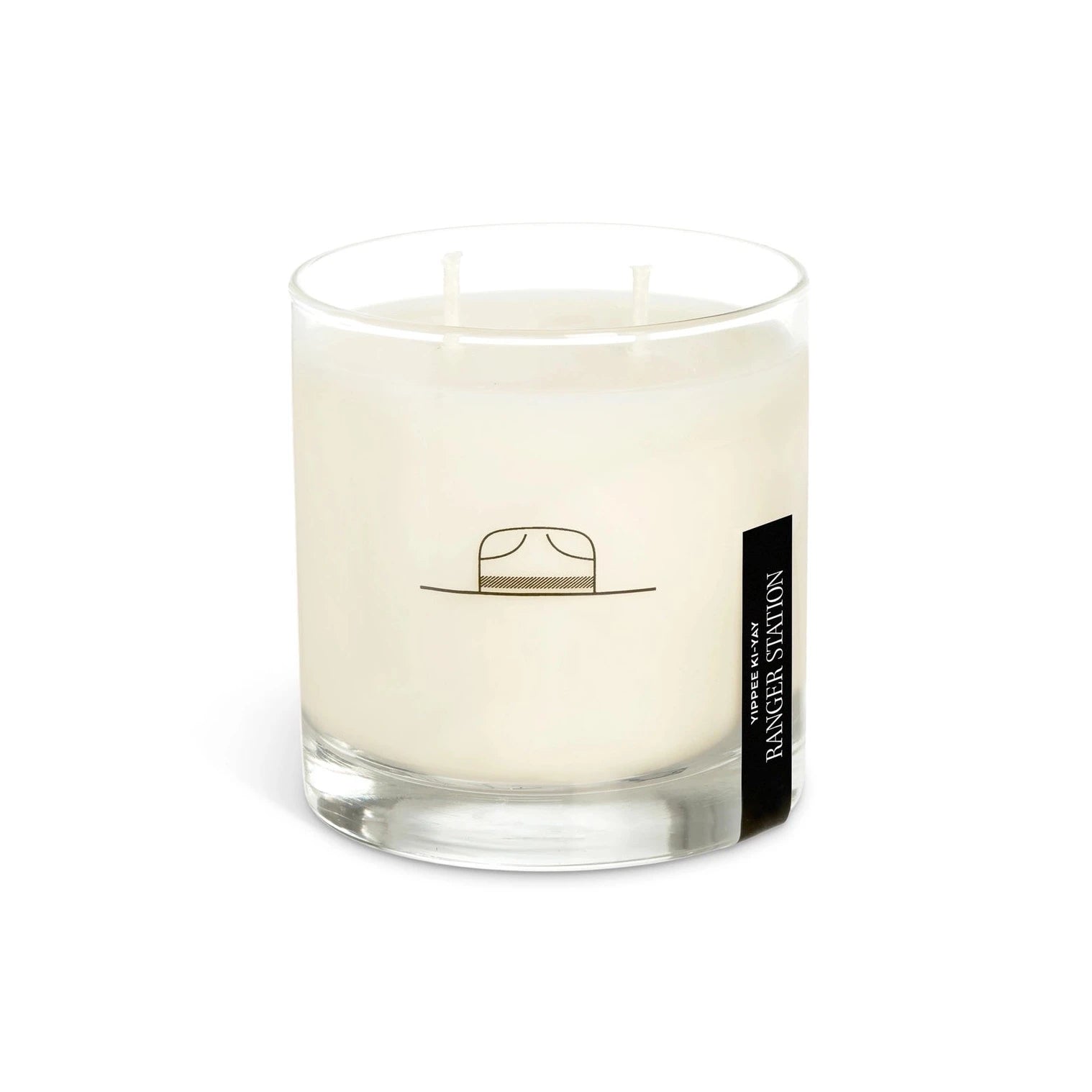 white candle with black illustration on it. on the right hand side is black sticker label