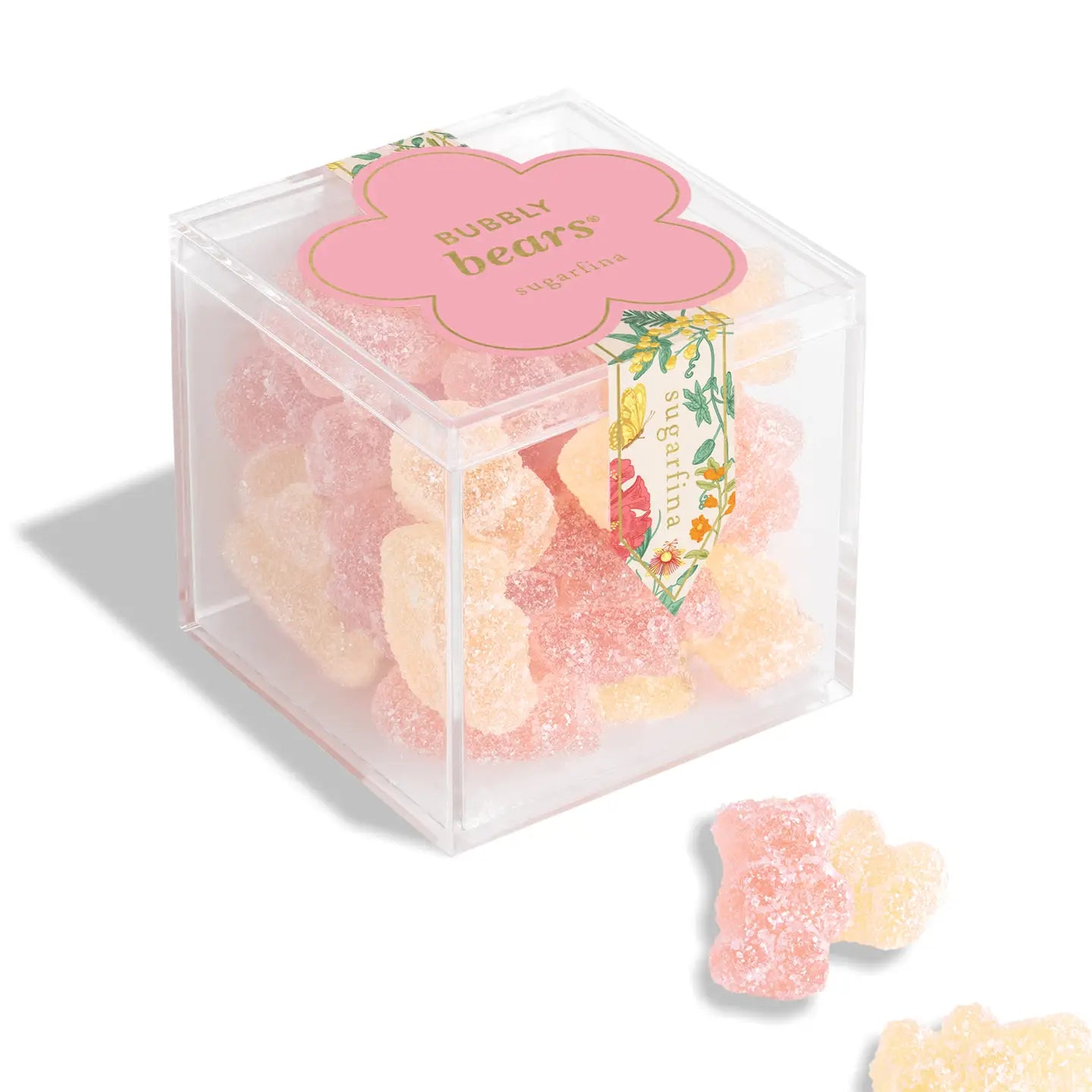 Clear cube box containing gummy bears with a pink label on a white background