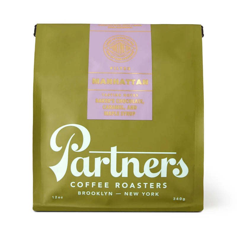 Green coffee bag with 'Partners Coffee Roasters' branding on a white background
