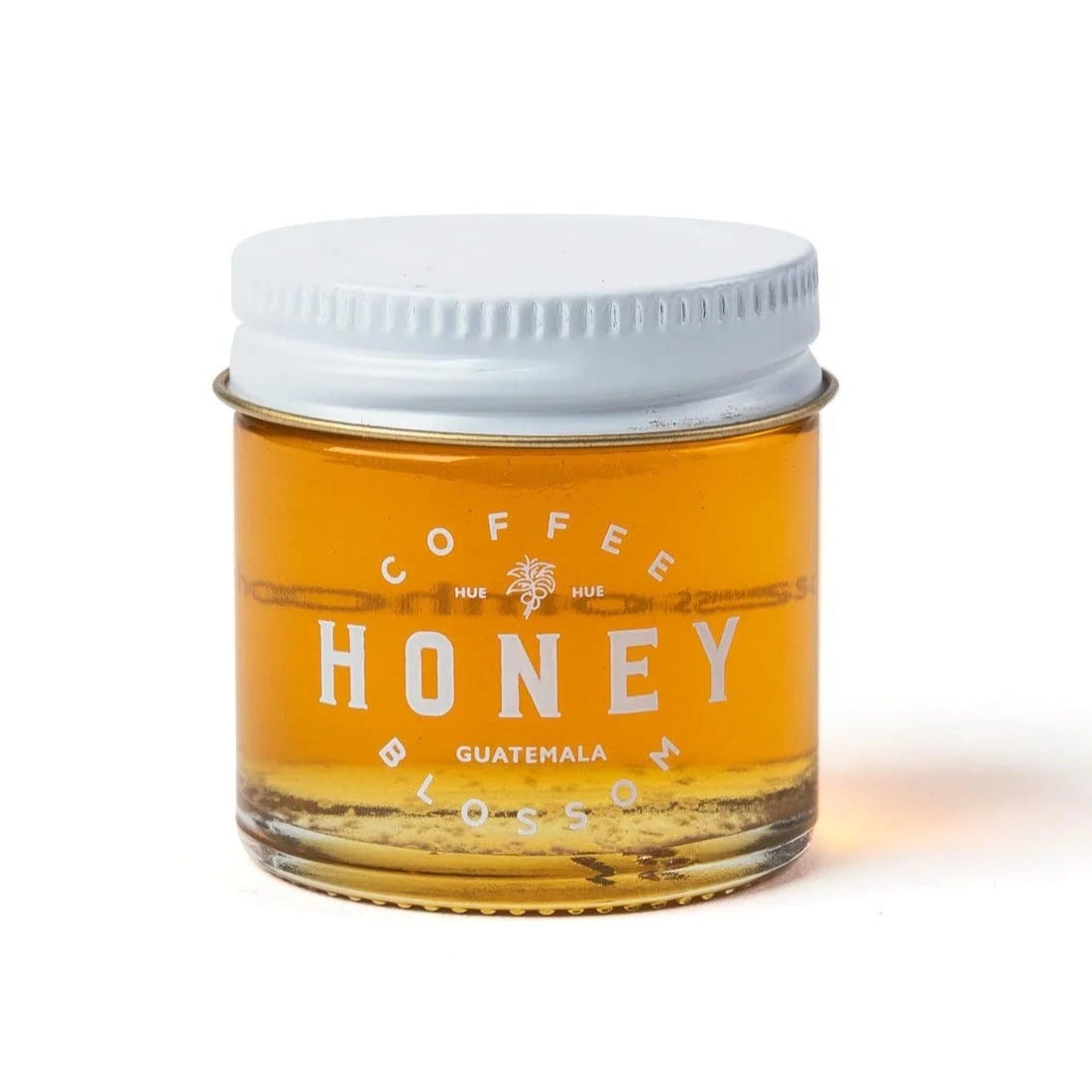 Jar of honey labeled 'Coffee Honey Guatemala' on a white background