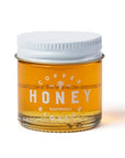 Jar of honey labeled 'Coffee Honey Guatemala' on a white background