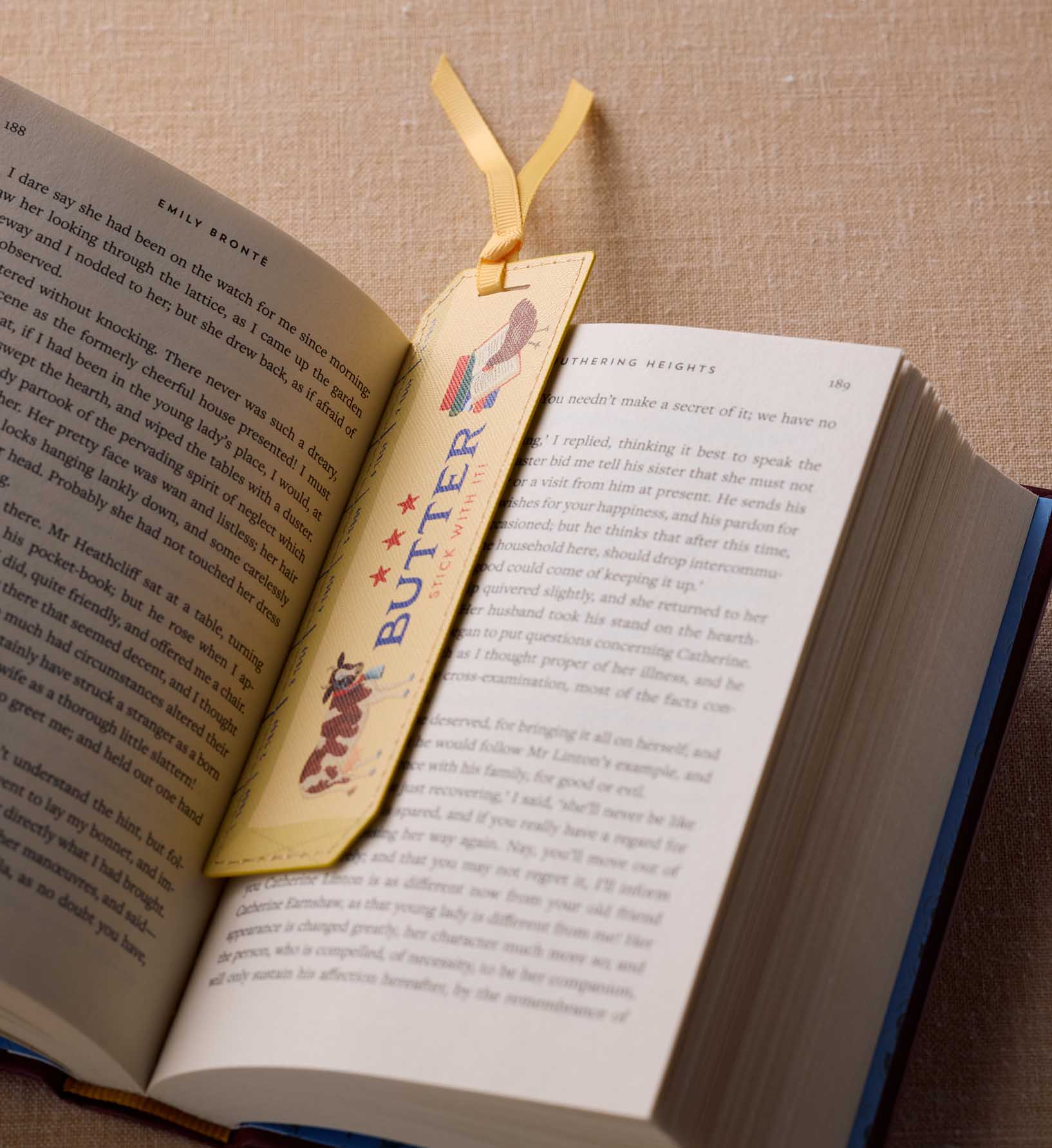 Open book with a decorative bookmark featuring the word 'BUTTER' on a textured surface.