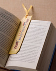 Open book with a decorative bookmark featuring the word 'BUTTER' on a textured surface.