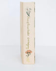 Book with decorative cover featuring floral illustrations on a white background