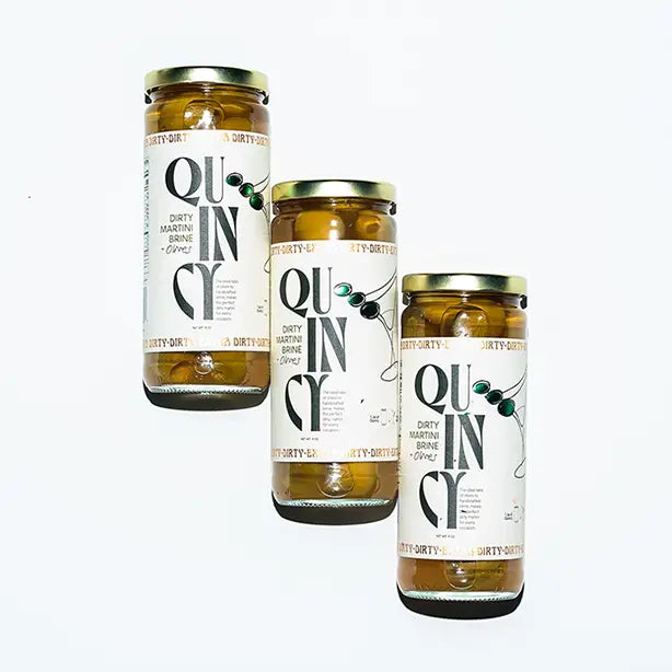 Three jars of Dirty Martini Olive Mix with 'Quincy' label on a white background