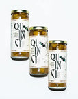 Three jars of Dirty Martini Olive Mix with 'Quincy' label on a white background