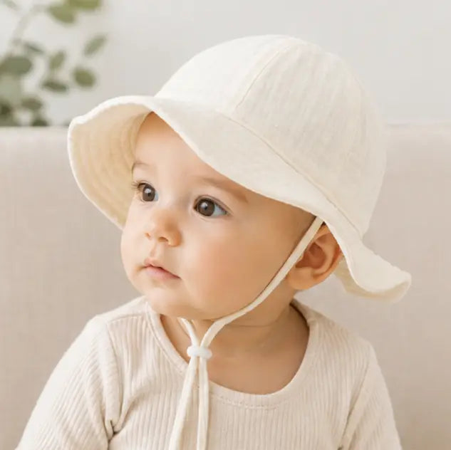 baby wearing a beige bucket hat