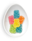 Colorful gummy bear candies on a white plate