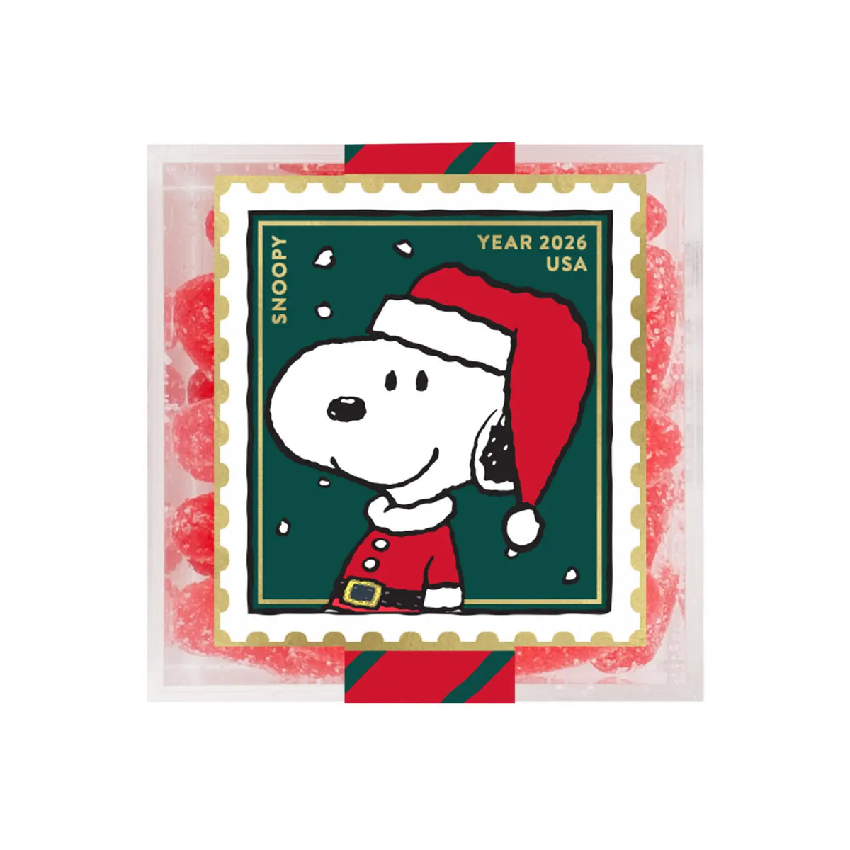 A square clear plastic package containing red, white, and green candy or gum pieces, featuring a Snoopy postage-stamp-style illustration with the text 'SNOOPY', 'YEAR 2026', and 'USA'.