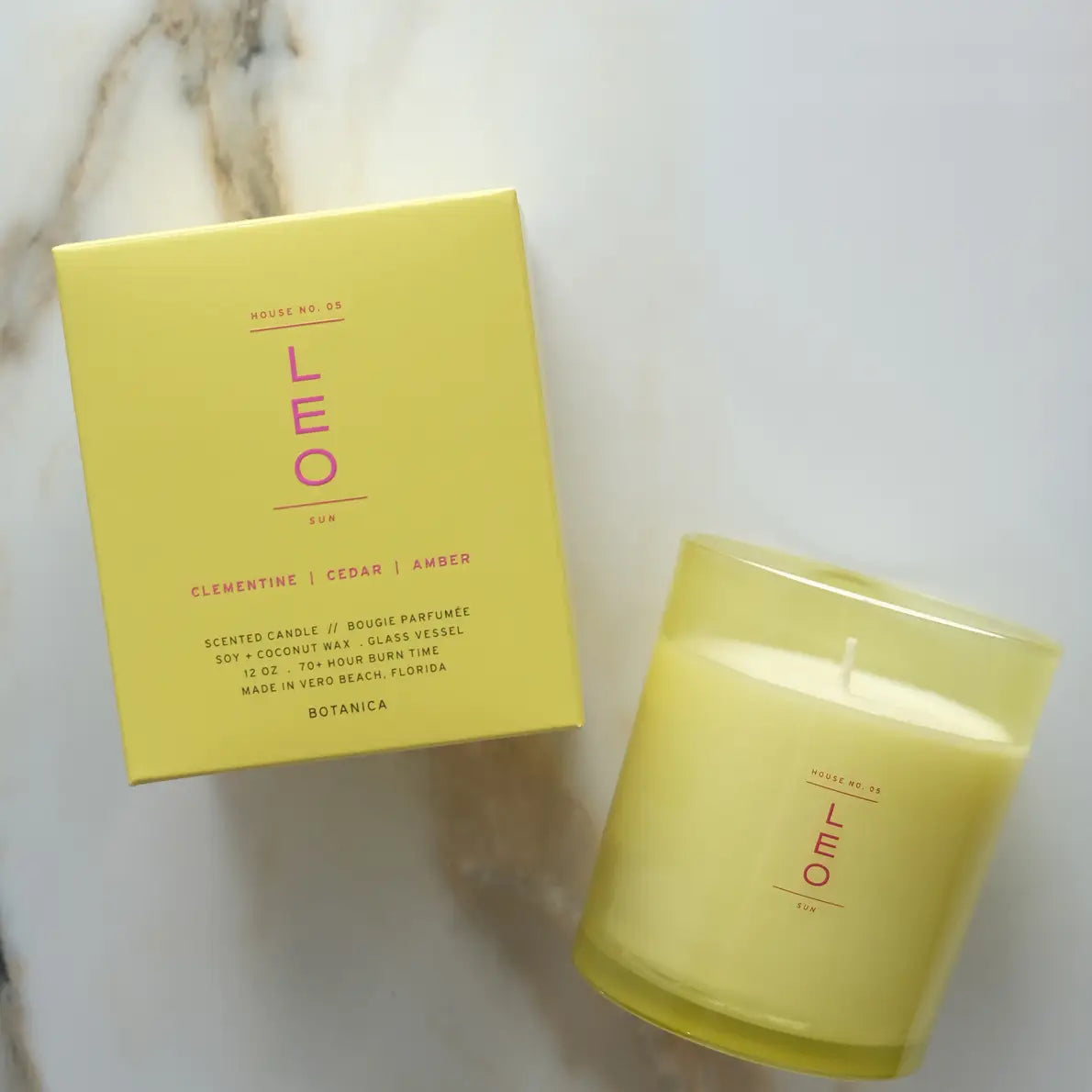 yellow leo zodiac candle on a marble background