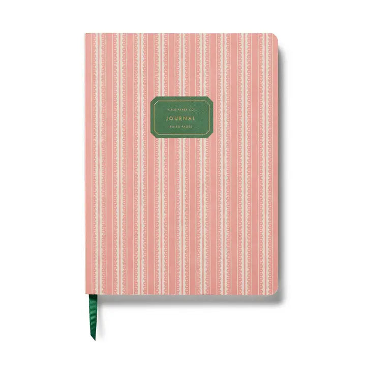 Pink striped journal with a green label on a white background