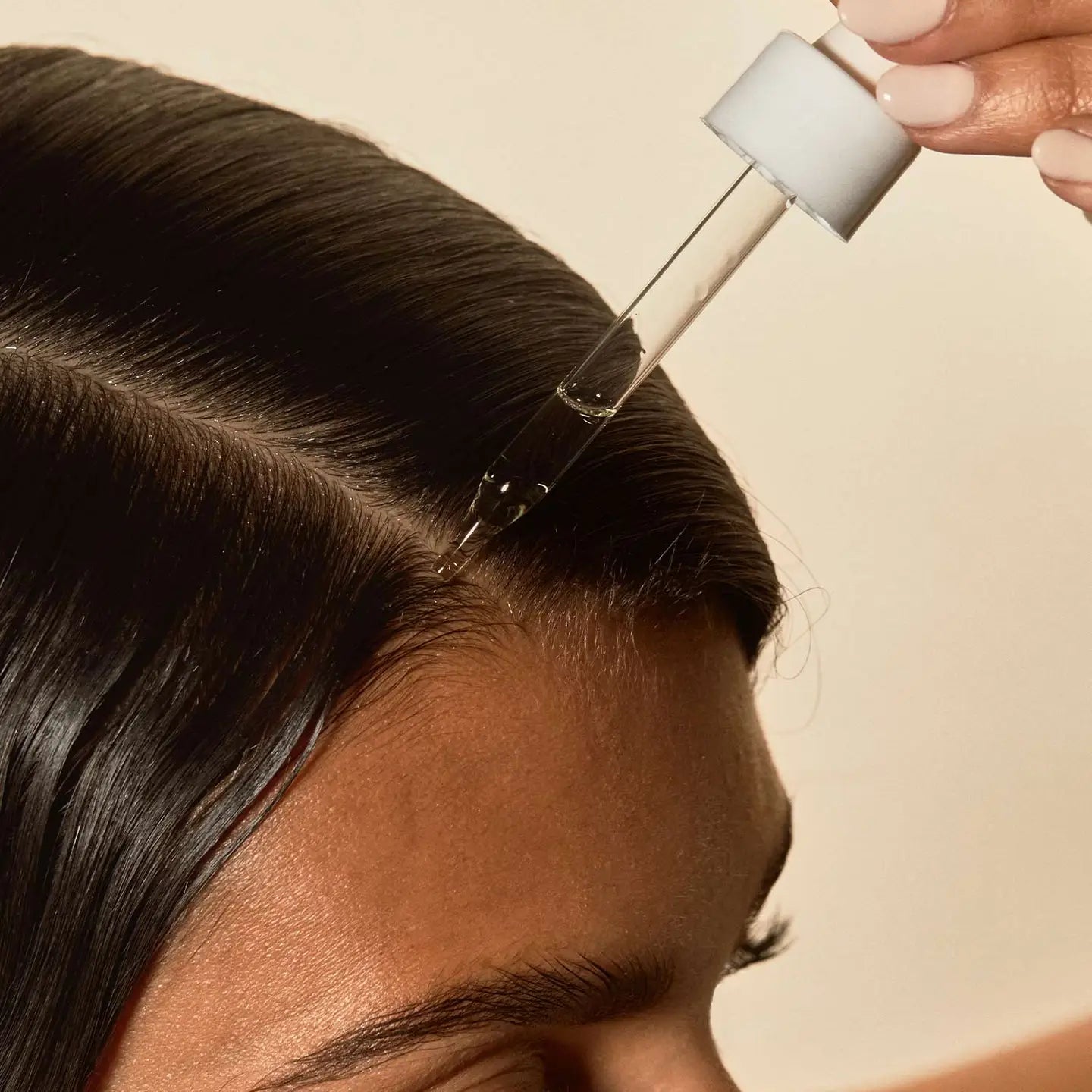 girl applying hair oil