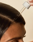 girl applying hair oil