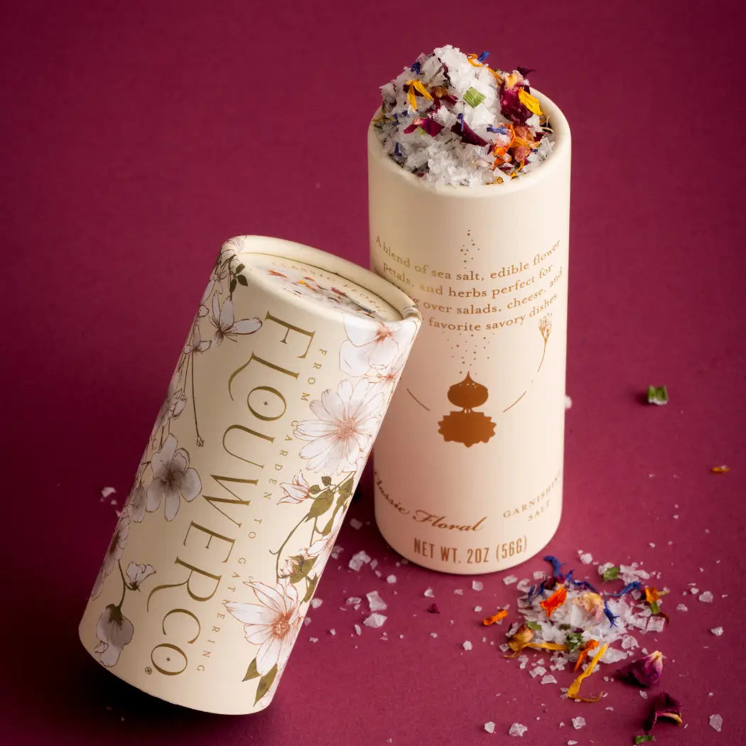 Two cylindrical containers of Flower Co. product on a purple background