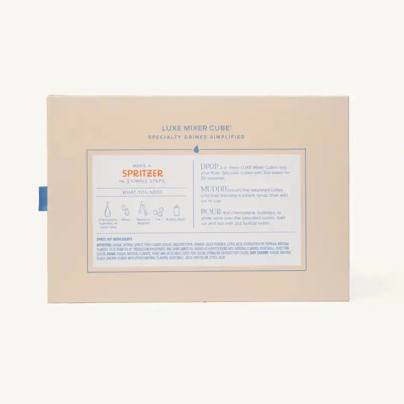 The back of a Luxe Mixer Cube spray bottle packaging box, showing product information and instructions in English and French, set against a plain off-white background.