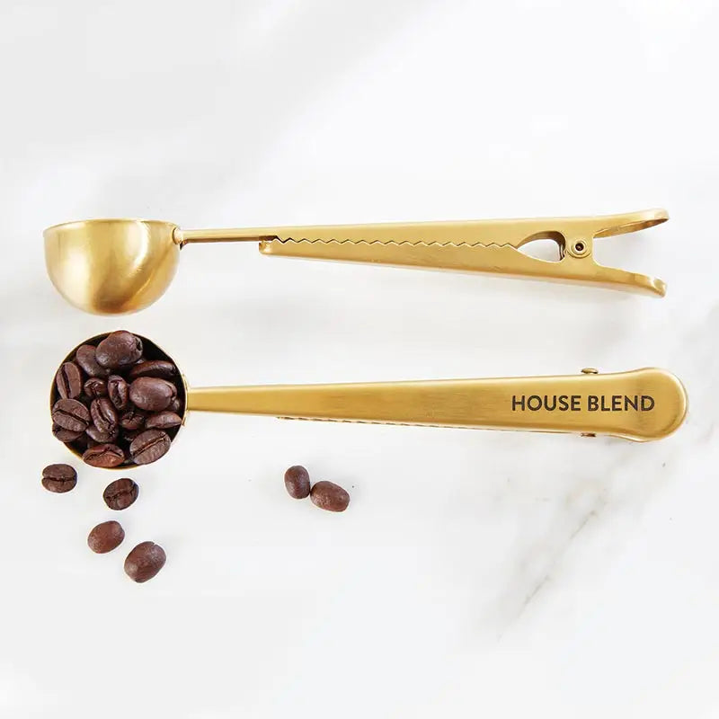 Gold coffee scoop with 'HOUSE BLEND' text and coffee beans on a white background