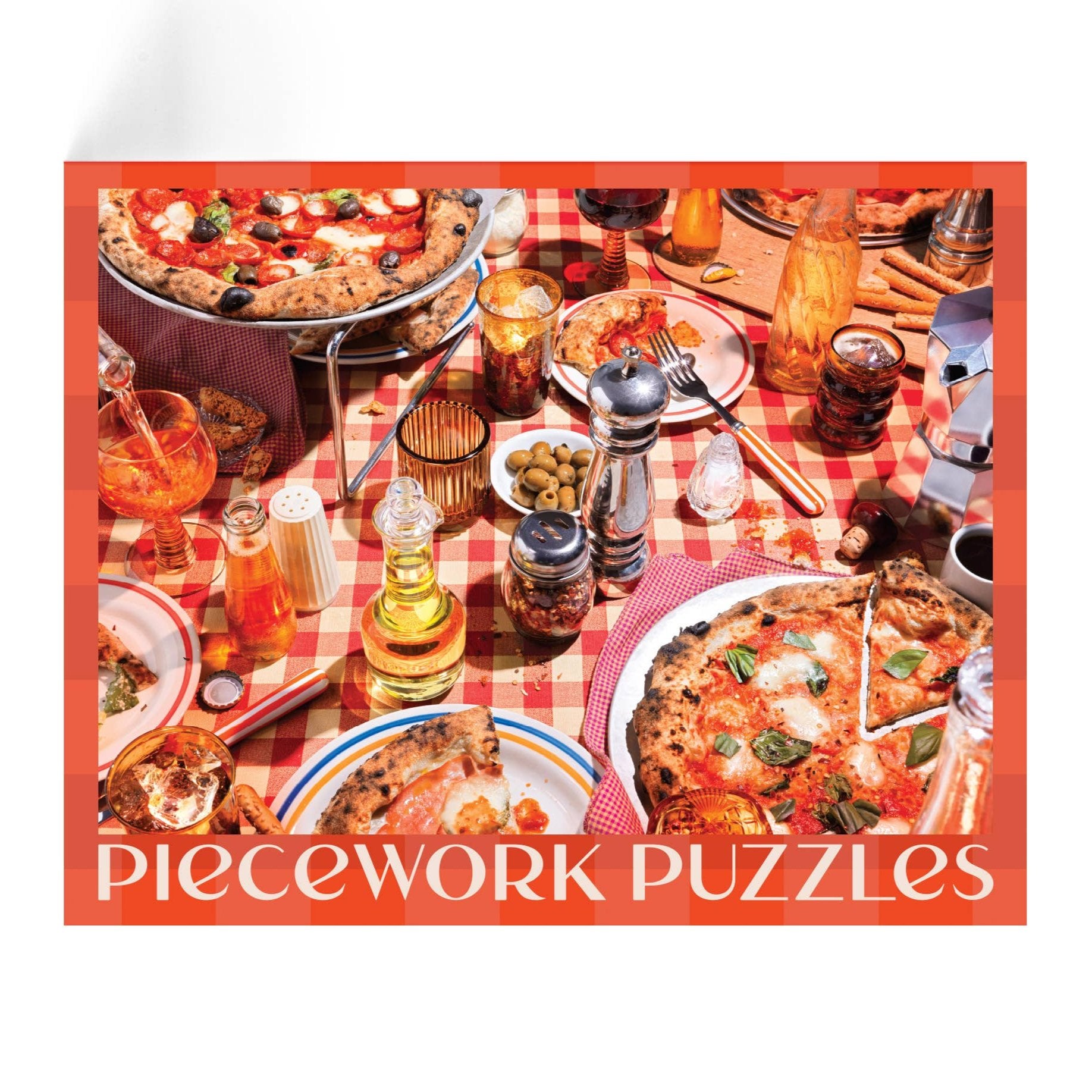 red puzzle with picture of pizzas on a red & white checkered tablecloth