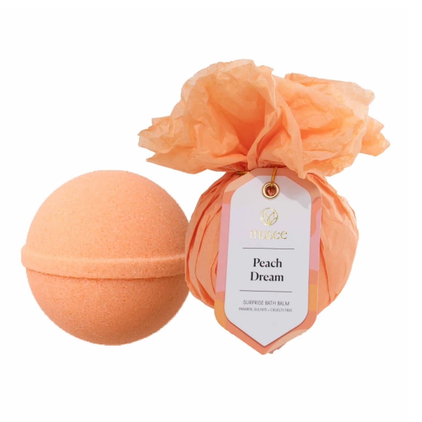 An orange peach bath bomb and matching bath topper set on a white background, with the bath topper wrapped in a paper band featuring a product tag labeled 'Peach Dream'.