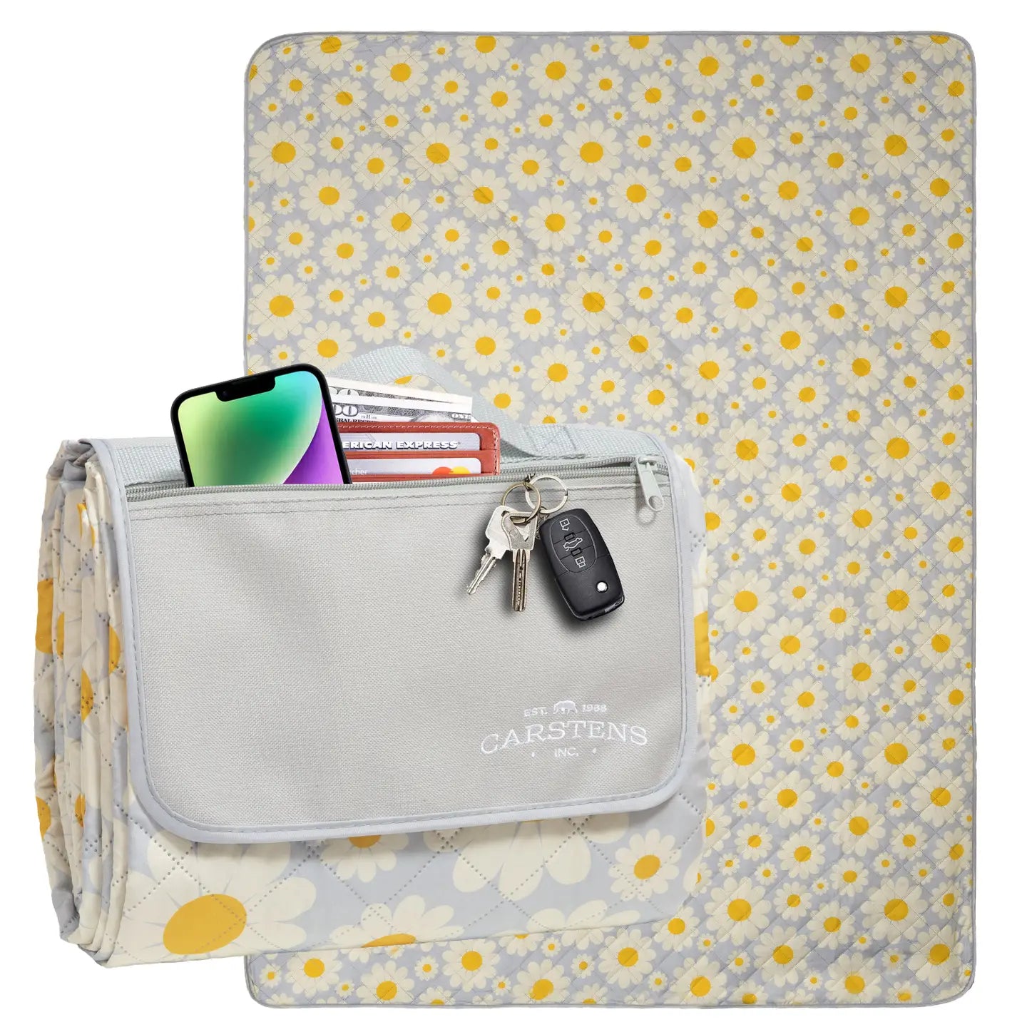 Floral-patterned outdoor blanket with a gray pocket holding a phone, cards, and keys on a white background.
