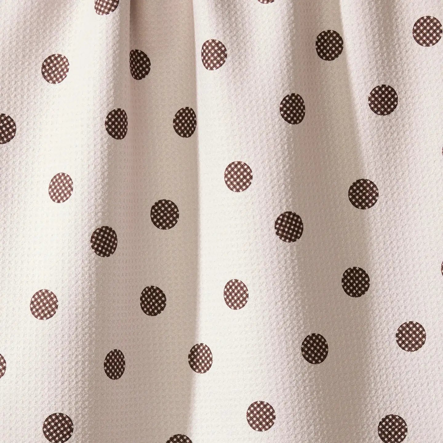 White fabric with brown polka dot pattern