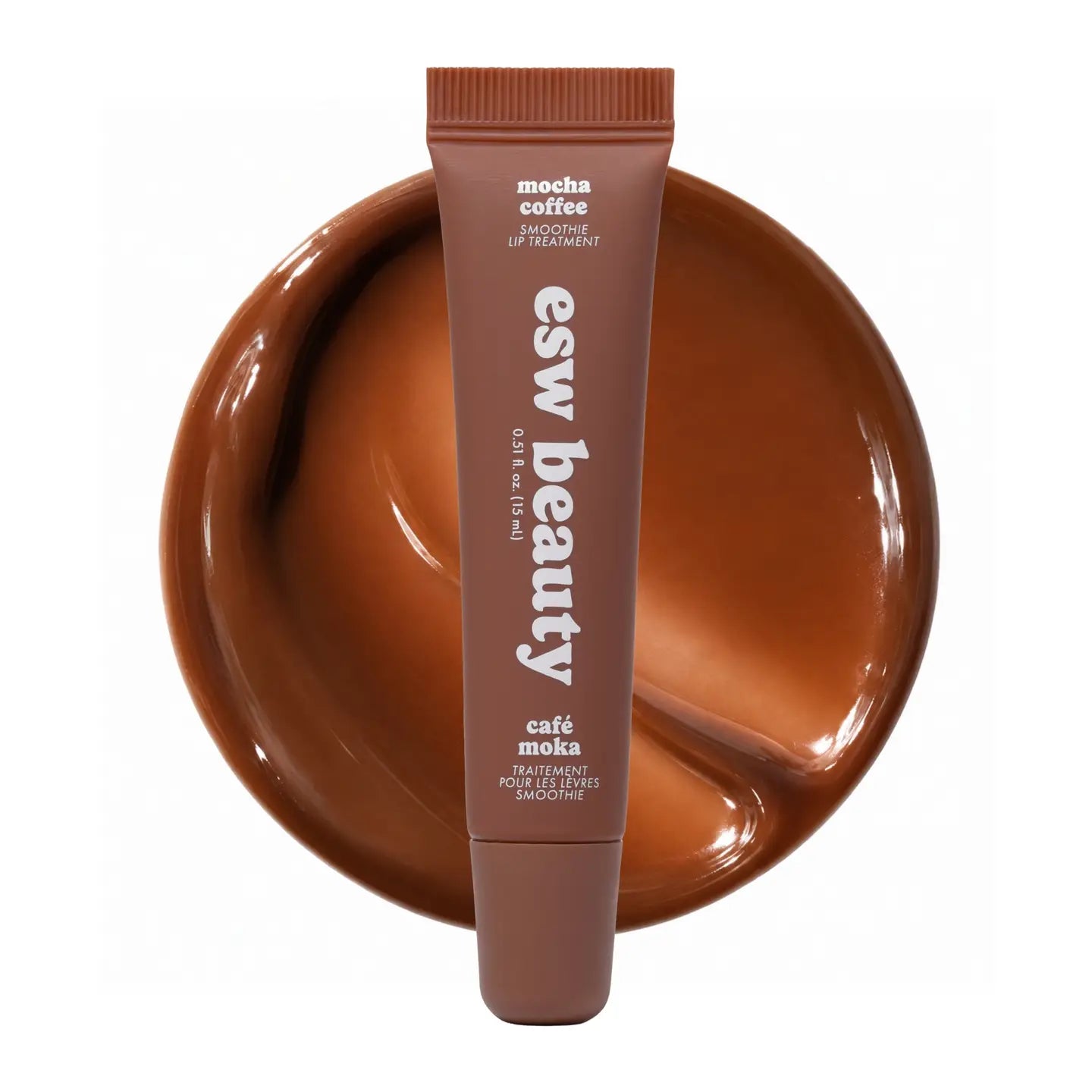 Lip treatment tube with 'esw beauty' branding on a brown plate