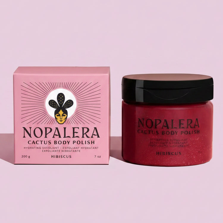 Nopalera Cactus Body Polish jar and its pink box on a light pink background, with a Gold Leaf Editor's Choice 2024 badge above. The jar contains a deep red polish and has a black lid, while the box is pink with a stylized face logo.