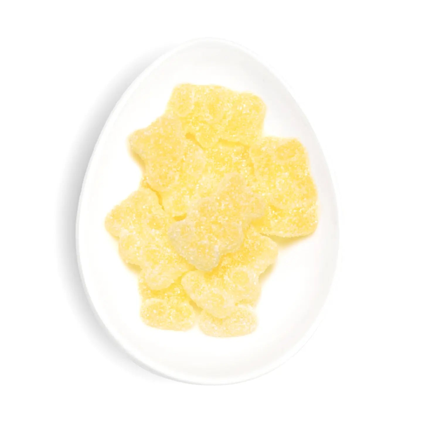 Yellow gummy bears on a white plate with a white background