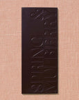 Dark chocolate bar with 'Spring & Mulberry' branding on a beige background
