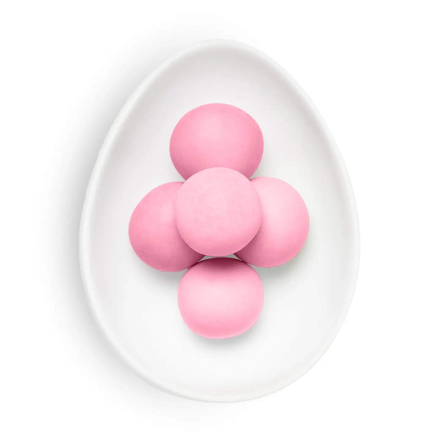 Pink candies on a white plate with a white background