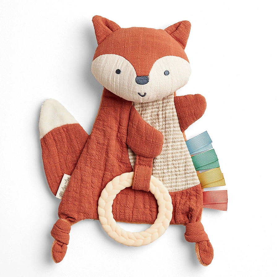 Plush fox toy with a ring on a white background