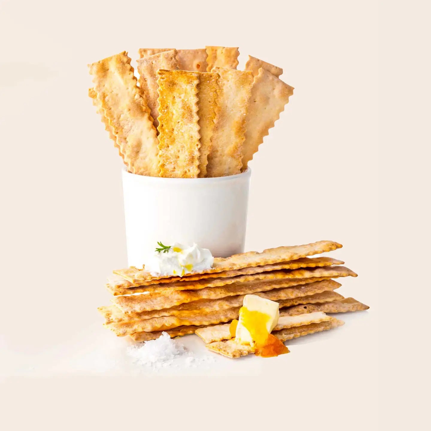 Puff pastry cups with a white cream filling on a light beige background