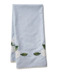 blue tea towel with white hydrangeas and green stems embroidered on it