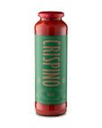 Bottle of Crispino basil sauce with a red cap on a white background