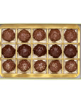 A top-down view of a rectangular box of 15 milk chocolate truffles arranged in a gold-colored tray on a white background.