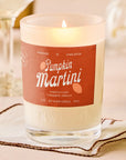 Candle labeled 'Pumpkin Martini' with a warm glow on a soft background