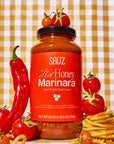 SAUZ Hot Honey Marinara sauce jar with tomatoes, a red pepper, and pasta on a checkered background
