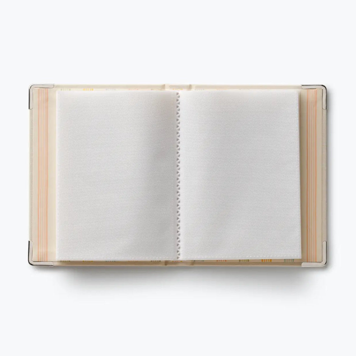 An open notebook with blank white pages, bound with a clear plastic cover and decorated with pastel stripes in pink, orange, and yellow on the left and right edges, shot from a top-down view on a white background.