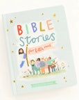 light blue book with bible stories printed on over and picture of jesus leading children