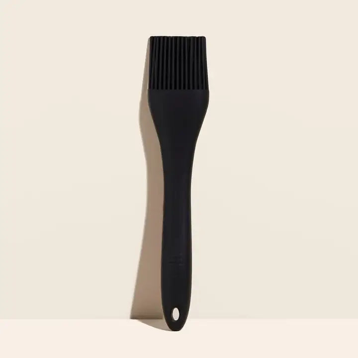 Black silicone brush on a beige background