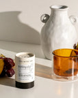 Tea packaging with a cup of tea and fruits on a light surface