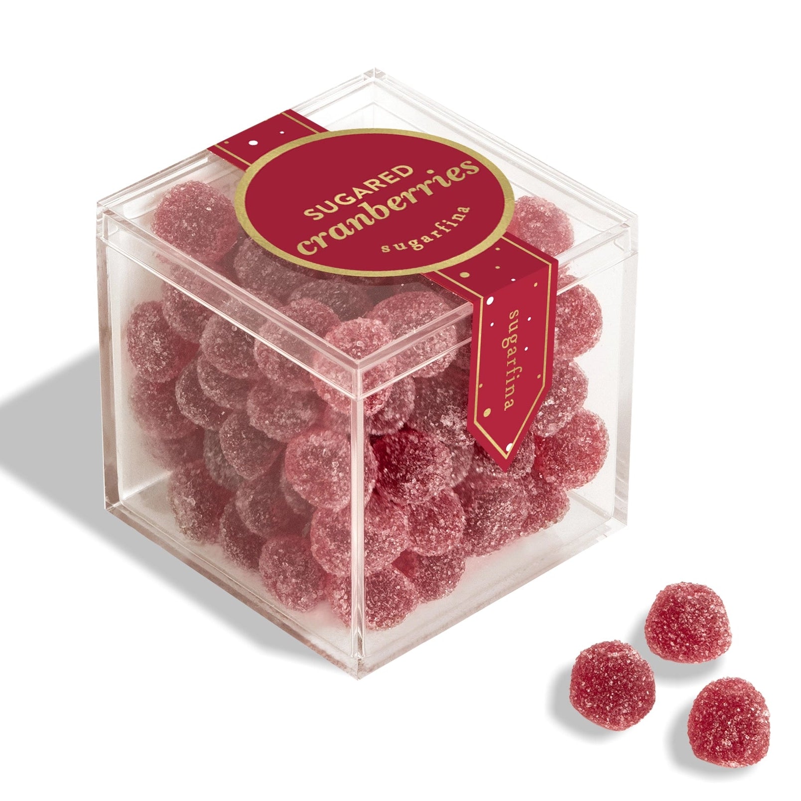 Box of sugared cranberries with a clear lid on a white background