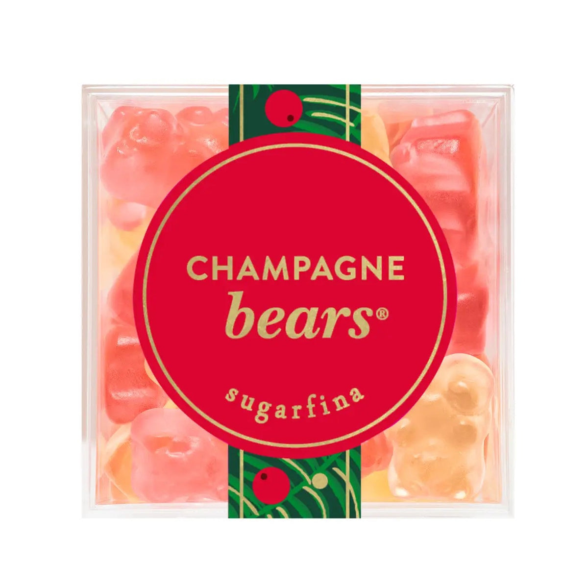 A clear square plastic container of Champagne bears sugarfina gummy candies, featuring a large red circular label with gold lettering and a green decorative band with red berries.