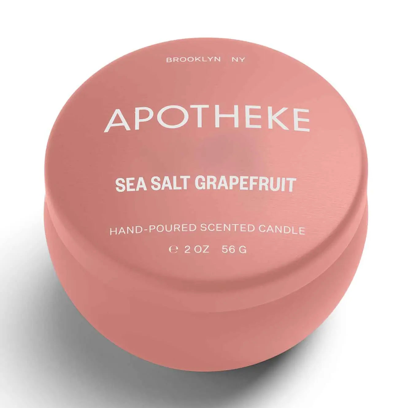 Pink candle container with 'Apotheke' branding and product details on a white background